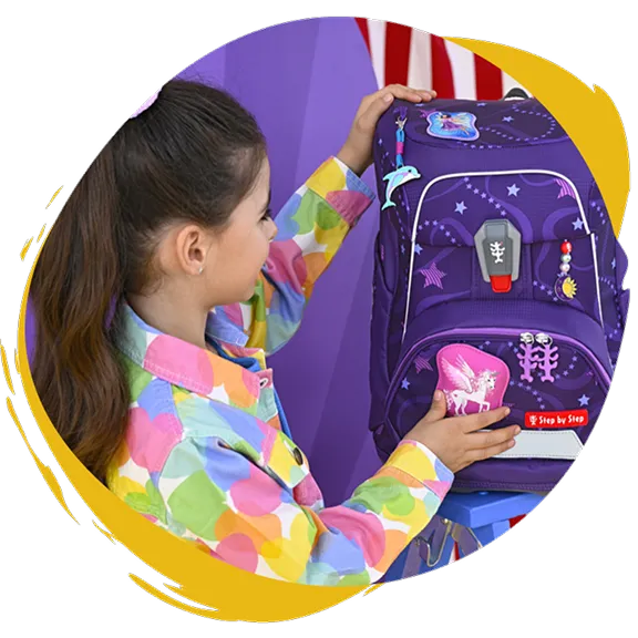 Mädchen bestaunt lila Schulranzen mit Einhörnern